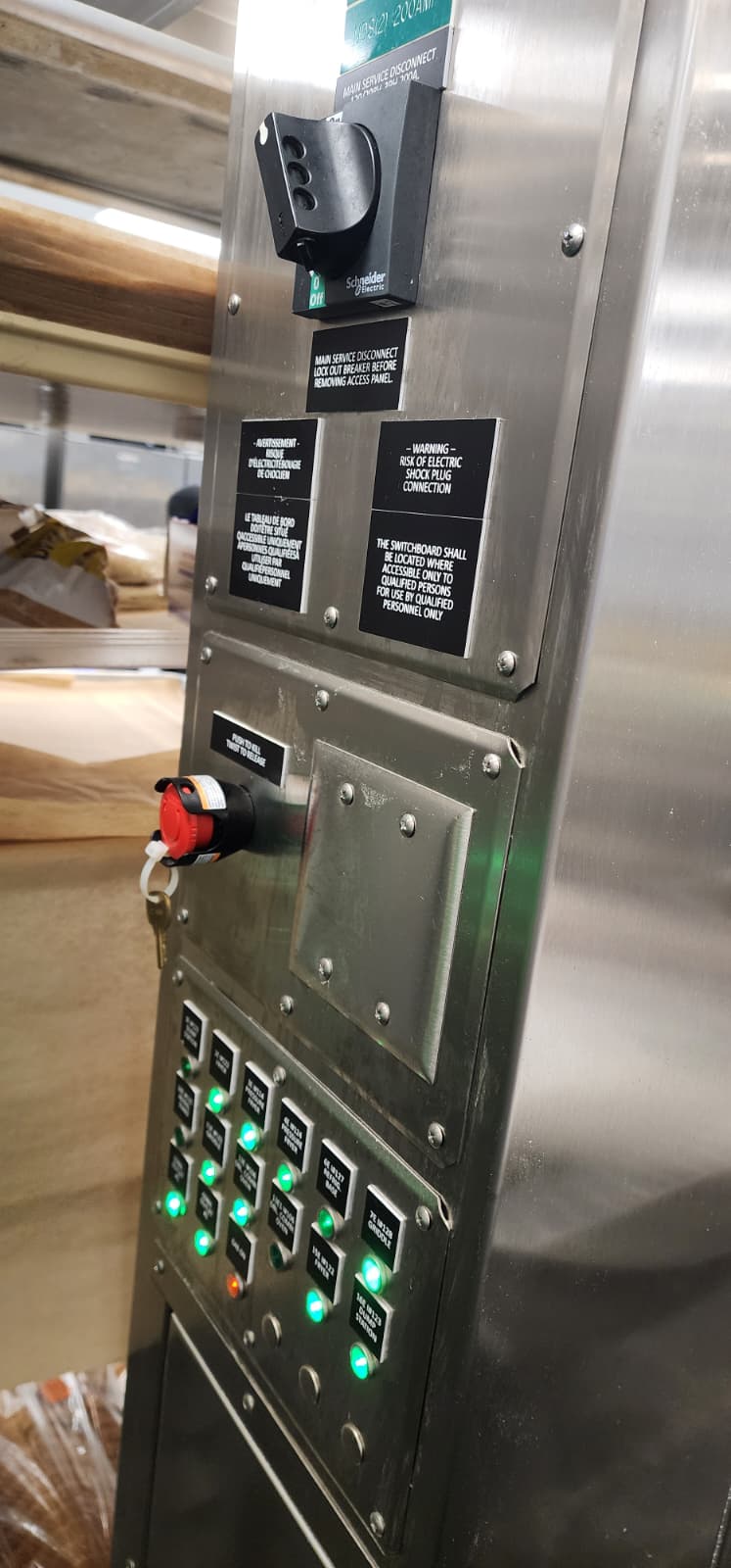Lower portion of the CaptiveAire Commercial Appliance Outlet Center showing a grid of green LED-illuminated breaker buttons individually labeled for each kitchen appliance — Cook & Hold Oven, Dbl Conv Oven, 60 Gal Kettle, Tilt Skillet, Combi Oven, Conv Steamer, and additional positions with GAS ON status LED in amber at bottom